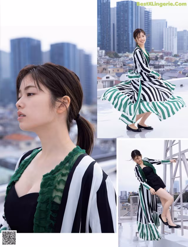 A woman in a black and white striped dress and green scarf.