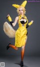 A woman in a yellow dress with a fox tail.