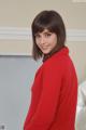 A woman in a red sweater posing for the camera.